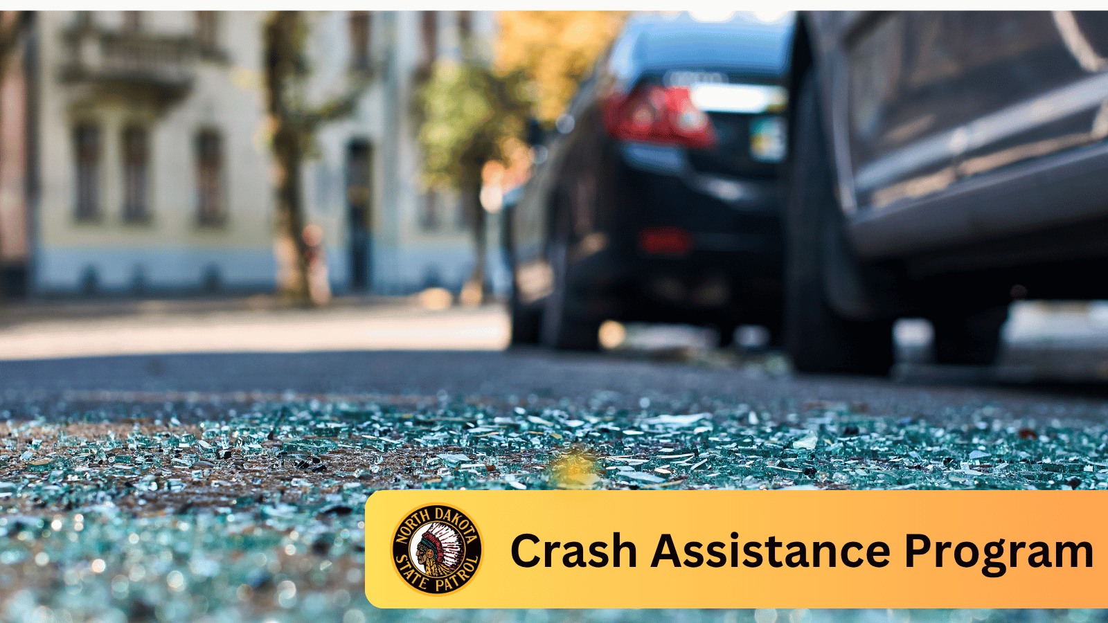 Crash scene with broken glass on pavement