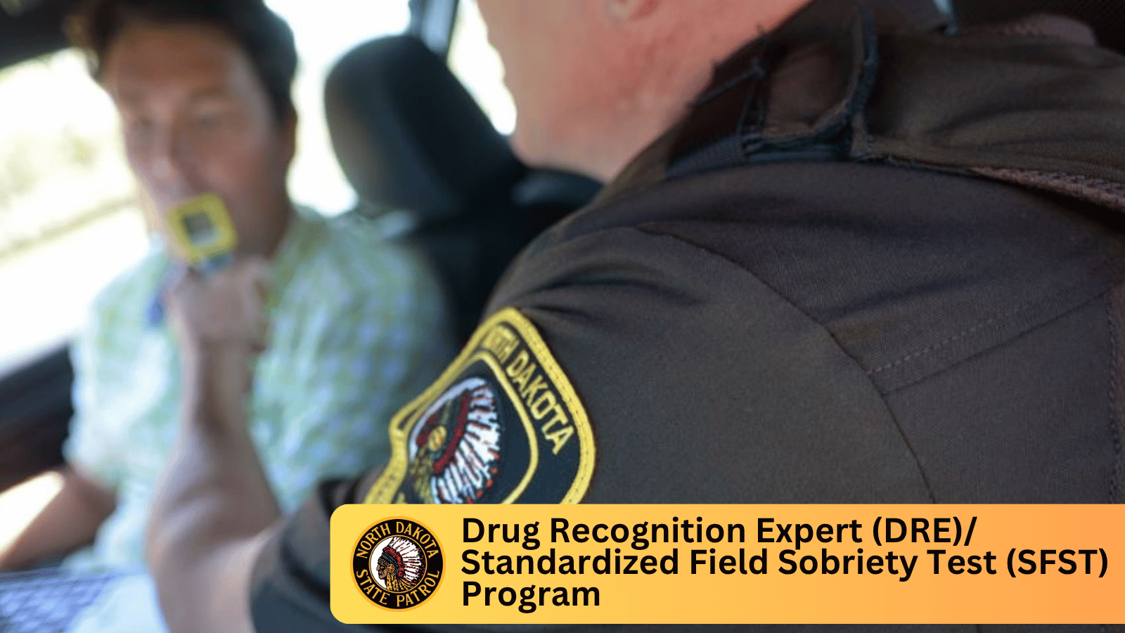 An officer administering a roadside breathalyzer test.